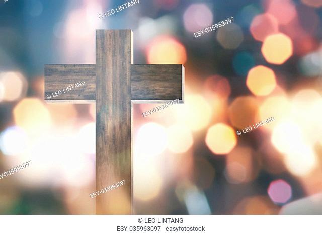 Wooden christian cross with bokeh light background