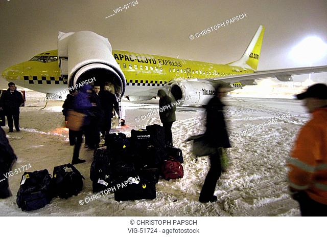 Chaos of snow at the Airport of Hamburg. Passenger airplane of the airline Hapag-Lloyd Express ( HLX ) on the manoeuvering area