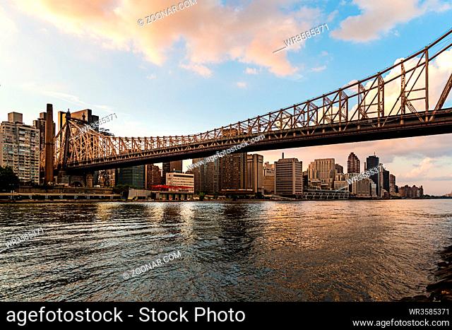 New York City / USA - JUL 27 2018: Queensboro Bridge view from Roosevelt Island at sunset