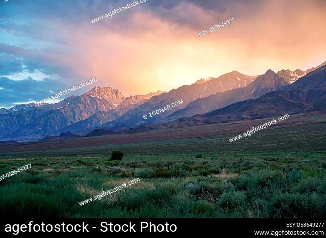 Mountain range with clouded colorful sunset, Eastern Sierra Nevada Mountains, Mono County, California, USA