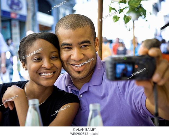 Couple taking a photo of themselves smiling