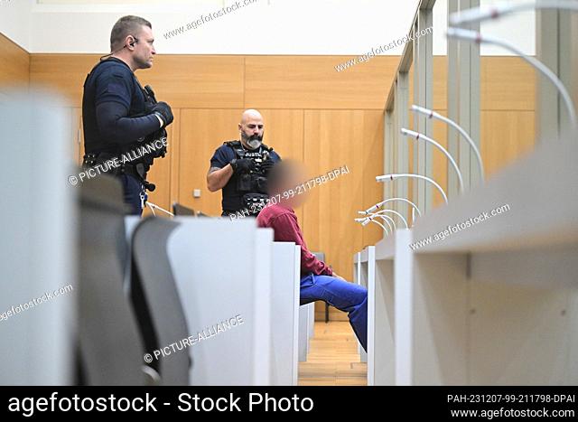 07 December 2023, Baden-Württemberg, Stuttgart: The defendant sits in a courtroom at the start of a trial for fifteen counts of attempted murder