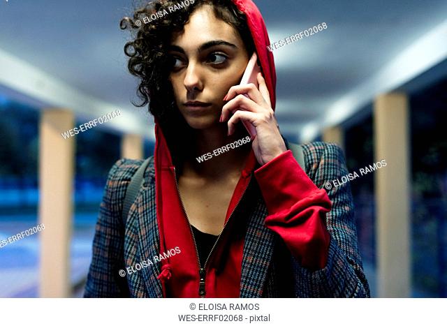 Portrait of young woman on the phone in the evening