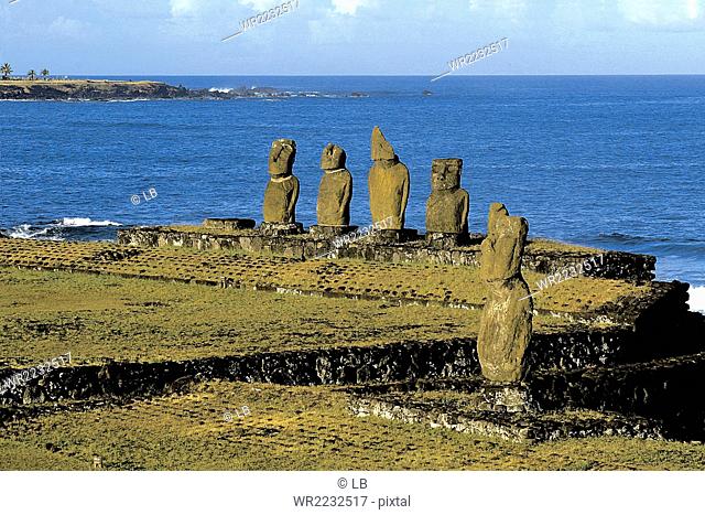 Chile, Ceremonial area of Tahai with the five Moai of the Ahu Vai Uri and solitary Ahu Tahi, Easter Island, Rapa Nui National Park, South America