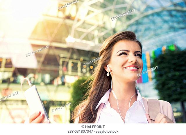 Beautiful young business woman with smart phone