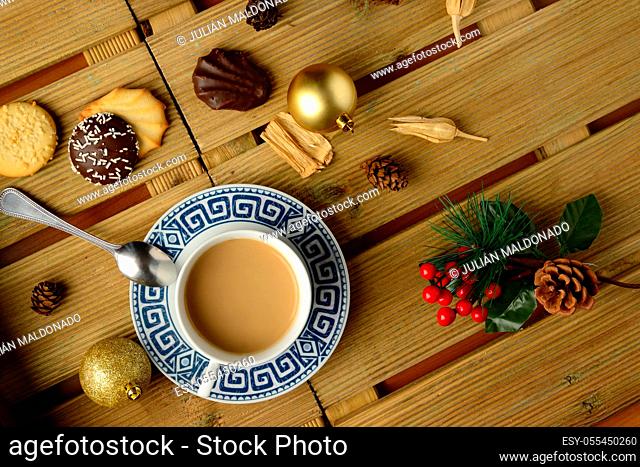 Cup of coffee with milk and pasta with Christmas decorations
