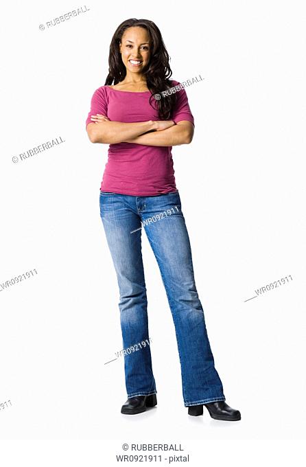 Woman in blue jeans standing with arms crossed