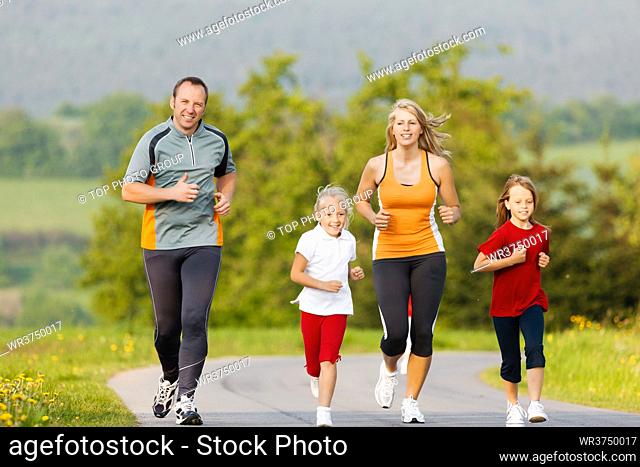 Family jogging for sport for fitness outdoors with the kids