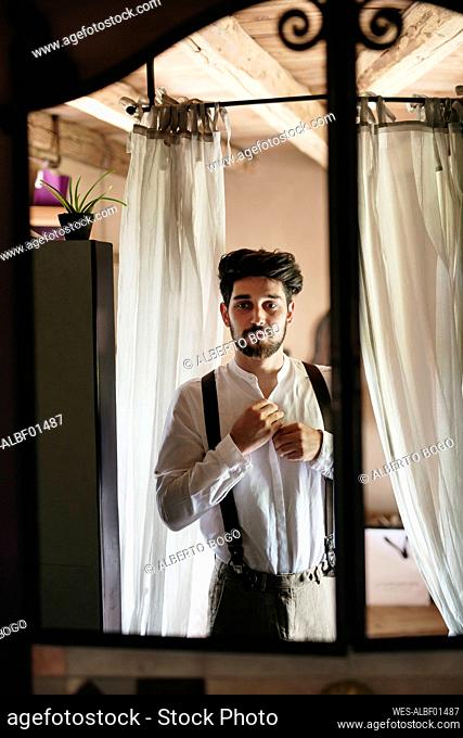 Groom getting ready for wedding at dressing room