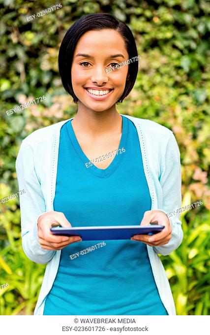 Smiling brunette using tablet