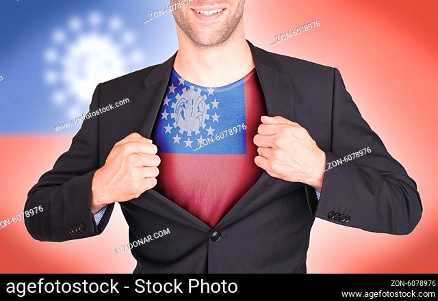 Businessman opening suit to reveal shirt with flag, Myanmar