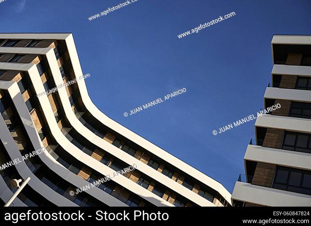 Modern building with ventilated facade against a blue sky with clouds, Bilbao, Basque Country, Spain