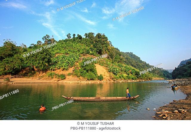 tribal people are carring goods by boat on the Sangu river at Tindu Bandarban, Bangladesh