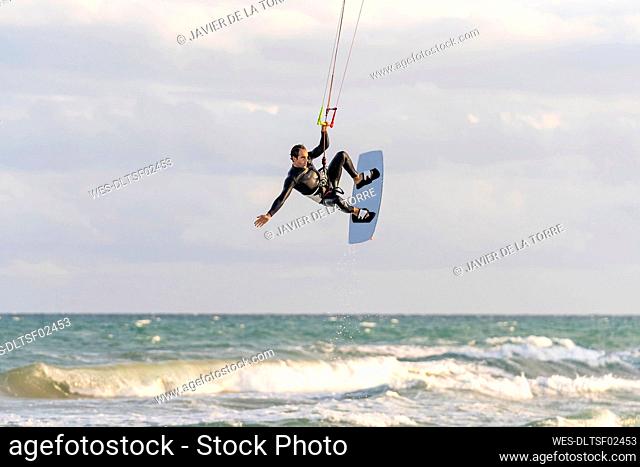 Man kiteboarding over sea on vacation