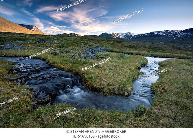 Midnight sun in the Fjaell Mountains with a small stream along the Kungsleden, The King's Trail, Lapland, Sweden, Europe