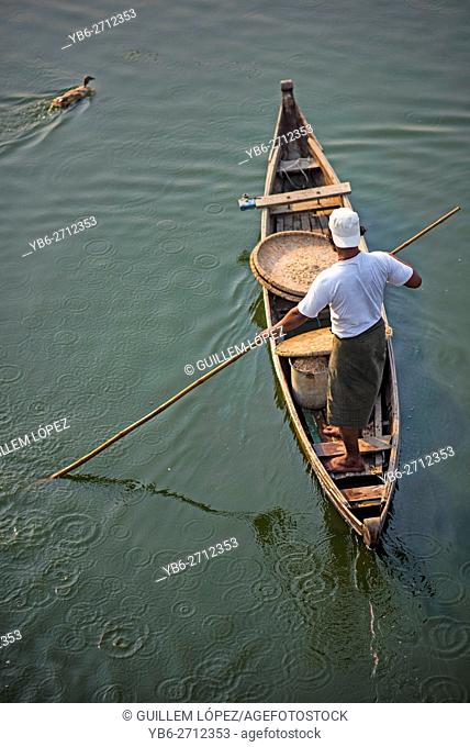 A duck herder in his boat at Taungthaman Lake, Amarapura, Myanmar
