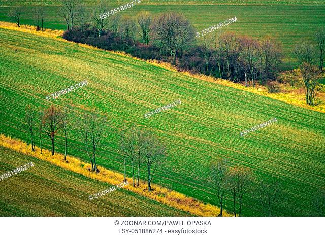 Aerial view of an empty field in winter among the rural landscape of Lower Silesia, Poland