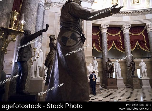 United States Representative Mike Rogers (Republican of Alabama) uses his phone in the quietness of Statuary Hall at the U.S