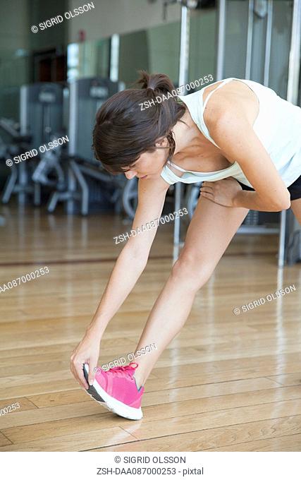 Woman stretching in health club