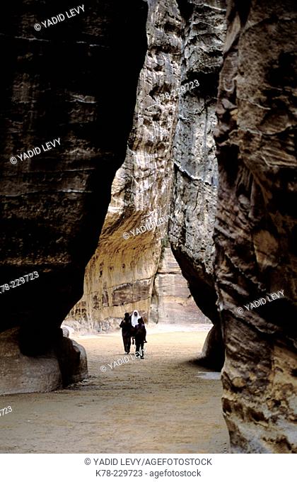 Bedouins walking inside the Siq, narrow gorge that leads to the Khasneh ('Treasury'). Petra. Jordan