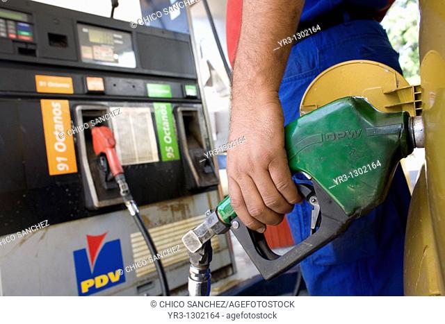 A workers pumps gas at a gas station in Caracas, Venezuela, July 23, 2008
