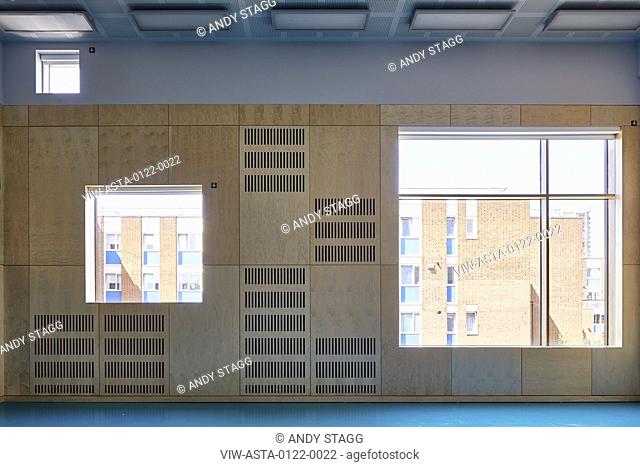 Gymnasium with square windows and view. Olga Primary School, London, United Kingdom. Architect: Architecture Initiative, 2017