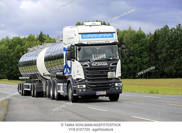 White Scania R730 tank truck for Haanpaa drives along highway on an overcast day of summer to pick up a load. Kaarina, Finland - June 29, 2018