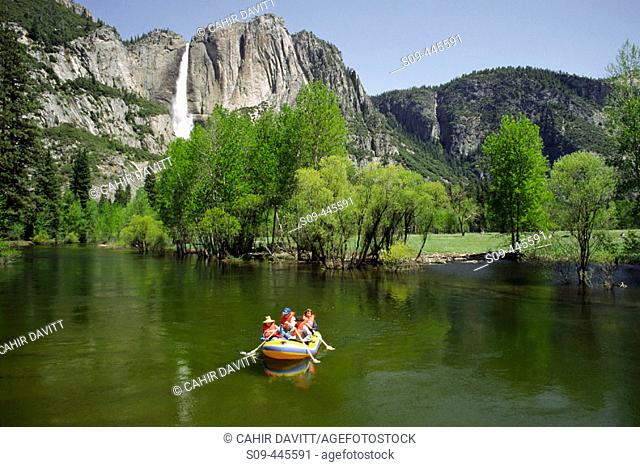 Rafting along the Merced River with the Upper Yosemite Falls in background, Yosemite National Park. California, USA