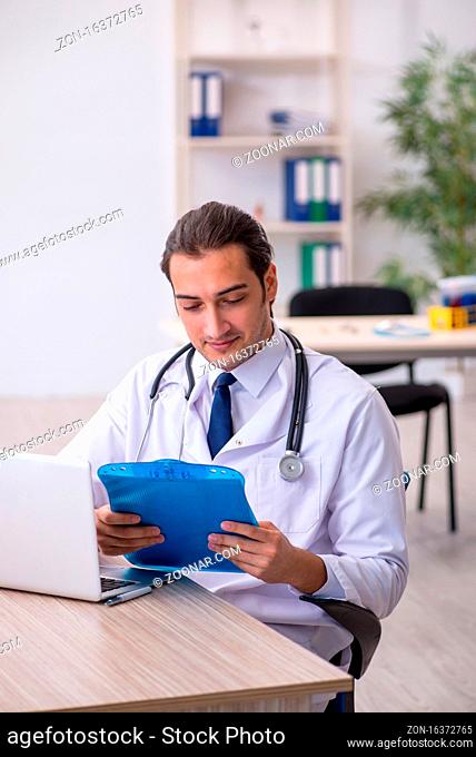 Young doctor taking notes at the hospital