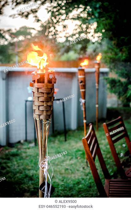 Burning tiki torch in the backyard