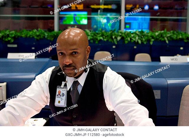 Flight director Kwatsi Alibaruho is pictured at his console in the space shuttle flight control room in the Mission Control Center at NASA's Johnson Space...