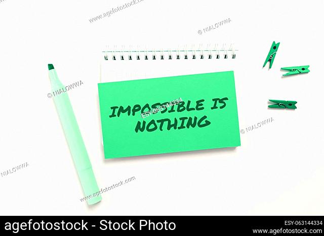Hand writing sign Impossible Is Nothing, Word Written on Something which is very difficult to accomplish