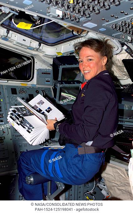 FILE: In this photo released by NASA, Astronaut Lisa M. Nowak, STS-121 mission specialist, uses a handy reference manual while stationed at the controls on the...