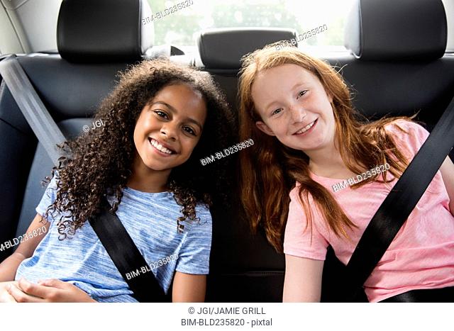 Portrait of smiling girls in car