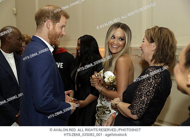 Britain's Prince Harry speaks to British singer Rita Ora and her mum Vera Sahatciu during a reception before a concert hosted by his charity Sentebale at...
