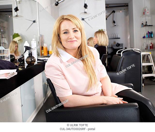 Hairdresser sitting in salon chair