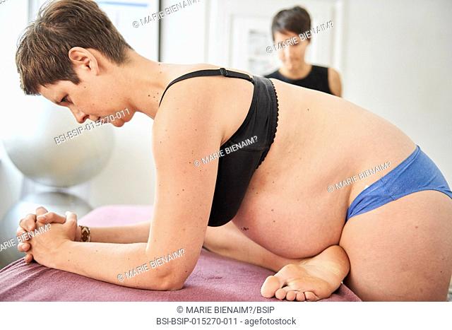Reportage in a physiotherapy practice in Lyon, France. The physiotherapist teaches a pregnant woman exercises to strengthen her perineum in order to maintain...