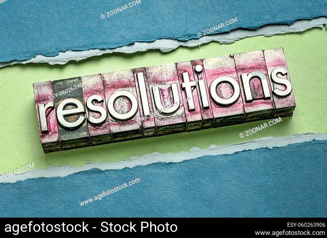 resolutions word abstract in gritty vintage letterpress metal types against colorful handmade rag paper, goal setting and personal development