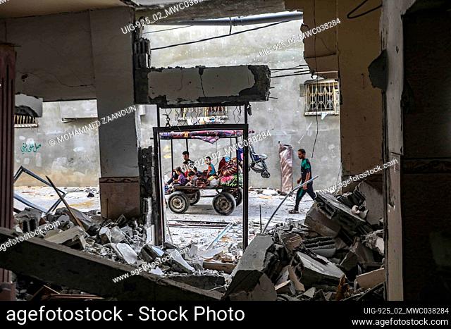People inspect the rubble of destroyed residential building which was hit by Israeli airstrikes, In the Beit Hanoun area in the northern Gaza Strip