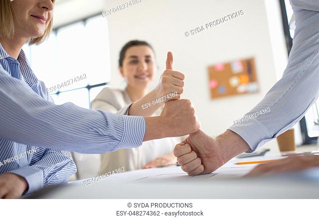 group of business team making thumbs up gesture