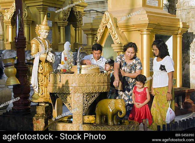 Offering to Buddha, planetary post for Mercury, Temple of Buddha Konagamana, Shwedagon Pagoda, Yangon, Burma, Myanmar, Rangoon, Asia