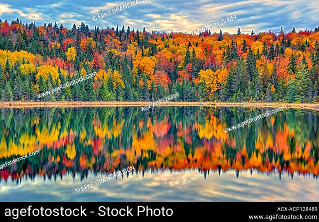 Autumn colors reflected in Lac Modène. Great Lakes - St. Lawrence Forest Region. La Mauricie National Park Quebec Canada