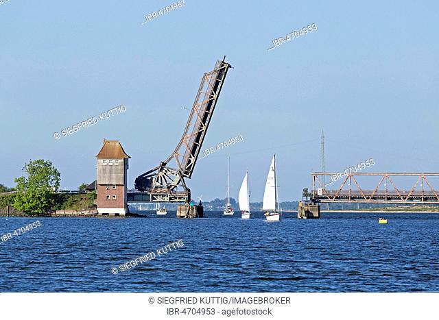 Sailboats sailing through open Schlei bridge, Lindaunis, Schlei, Schleswig-Holstein, Germany