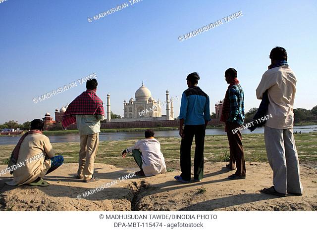 Local villagers viewing at Taj Mahal Seventh Wonders of World on south bank of Yamuna river , Agra , Uttar Pradesh , India UNESCO World Heritage Site