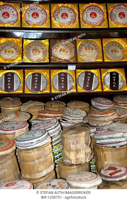 Pu-erh tea, Pu'er tea (Camellia sinensis), storage, packaging and sale as tea cakes and in bamboo, Lijiang, Yunnan Province, People's Republic of China, Asia
