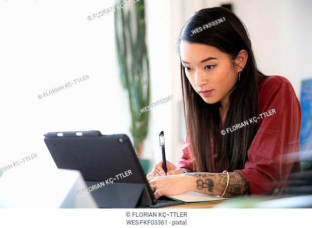 Woman using tablet in office