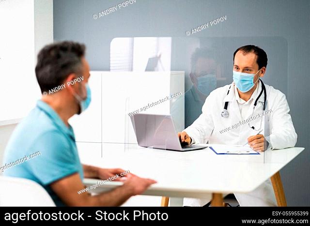 Elder Patient In Doctor Office Or Hospital With Sneeze Guard Screen And Mask