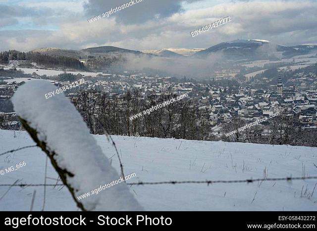 Fence with the background of the german area called Rothaargebirge at winter