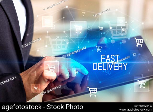 Young person makes a purchase through online shopping application with FAST DELIVERY inscription