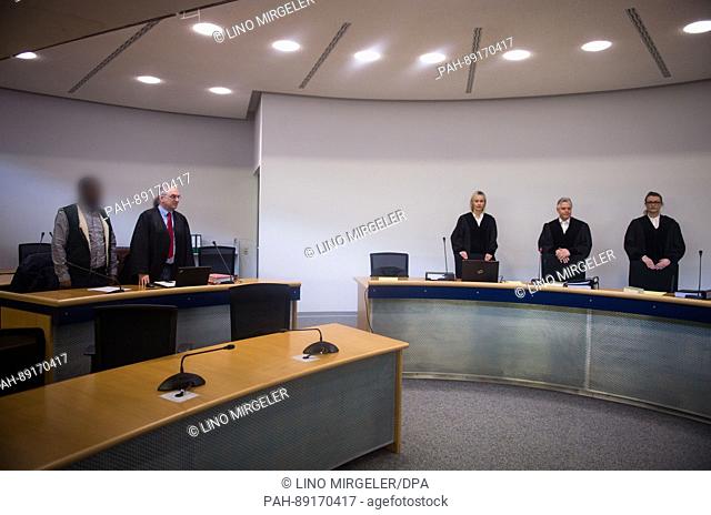 The defendant (L) in a trial concerning suspected support for an overaseas terrorist network stands in room 18 of regional court in Stuttgart, Germayn